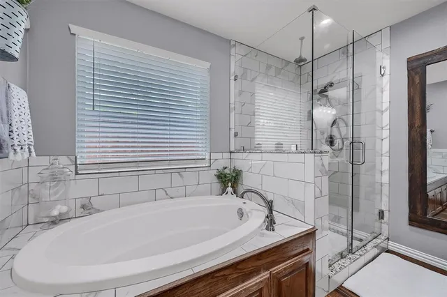a bath tub sitting next to a shower