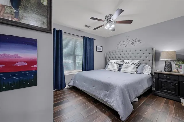 a bedroom with a bed and a chandelier