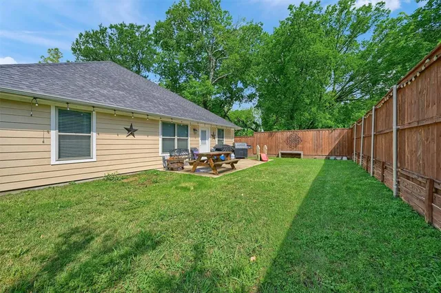 a backyard of a house with table and chairs