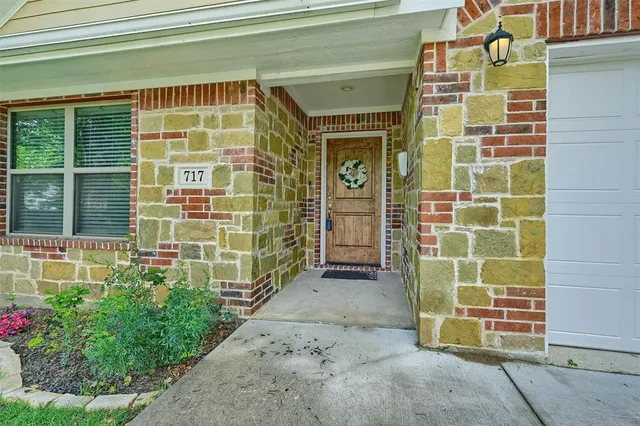 a view of a door with a door and wooden bench