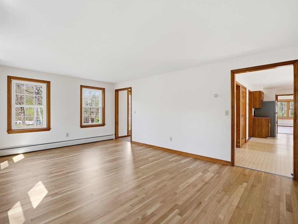26 Nevada Road Tyngsborough, MA 01879 - Photo 13 of 42 an empty room with wooden floor and windows