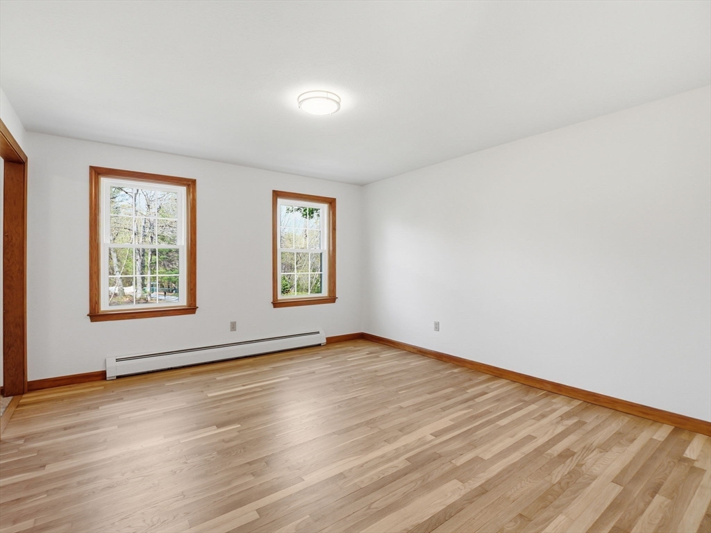 26 Nevada Road Tyngsborough, MA 01879 - Photo 14 of 42 an empty room with wooden floor and windows