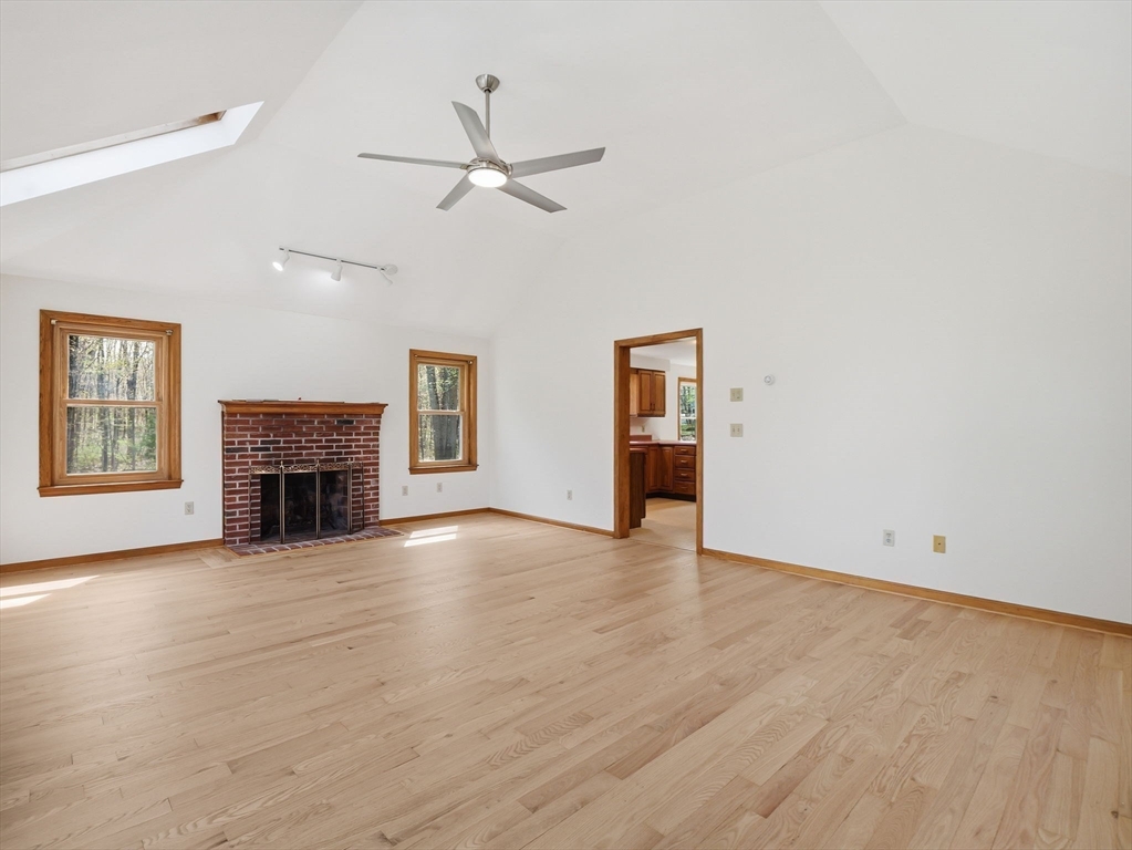 26 Nevada Road Tyngsborough, MA 01879 - Photo 15 of 42 a view of a livingroom with a fireplace and ceiling fan