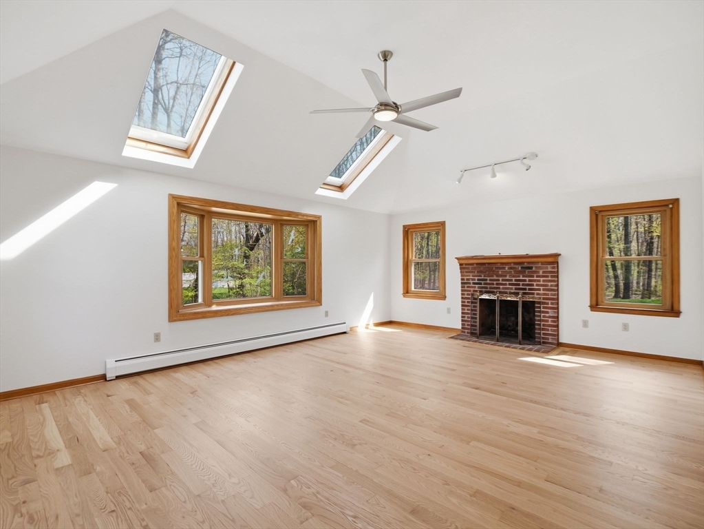 26 Nevada Road Tyngsborough, MA 01879 - Photo 16 of 42 a view of an empty room with a window and fireplace