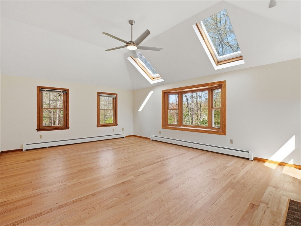 26 Nevada Road Tyngsborough, MA 01879 - Photo 17 of 42 a view of an empty room with wooden floor and a window