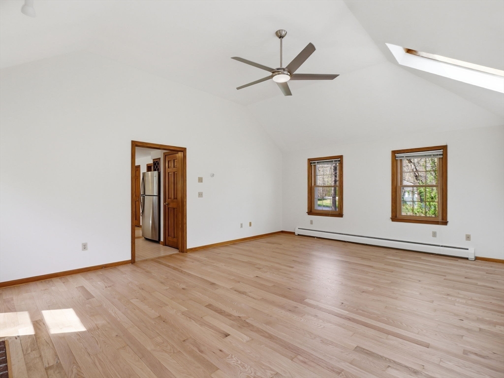 26 Nevada Road Tyngsborough, MA 01879 - Photo 18 of 42 an empty room with wooden floor ceiling fan and windows