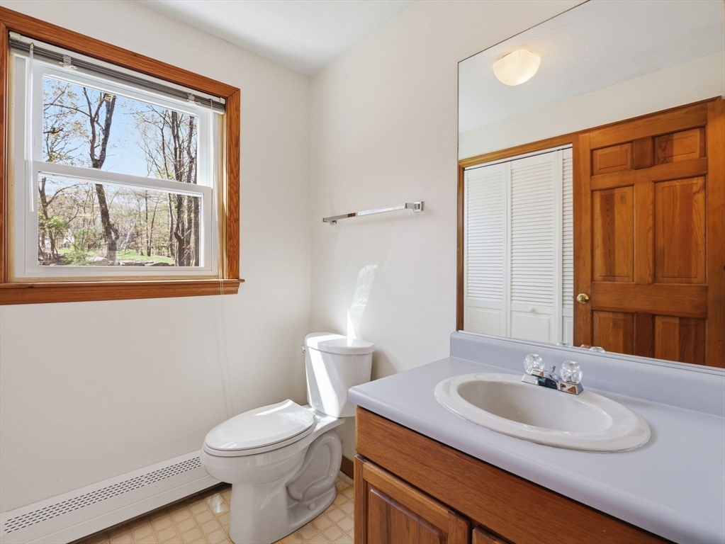 26 Nevada Road Tyngsborough, MA 01879 - Photo 19 of 42 a bathroom with a toilet sink and mirror