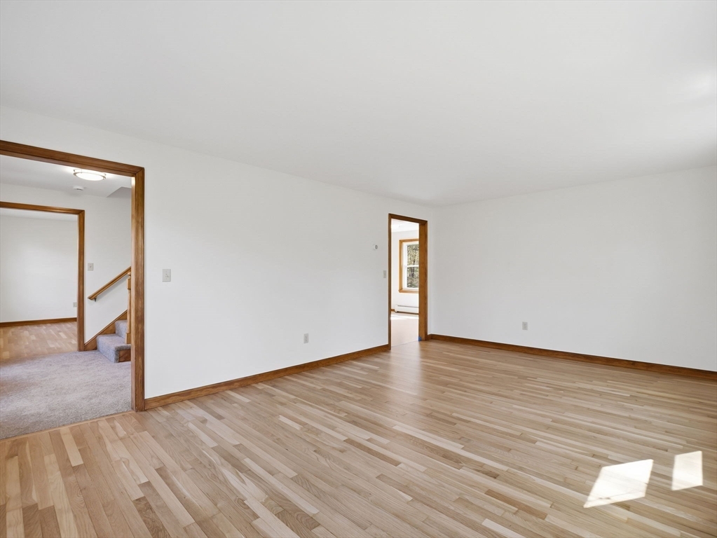26 Nevada Road Tyngsborough, MA 01879 - Photo 20 of 42 a view of an empty room with wooden floor and a window