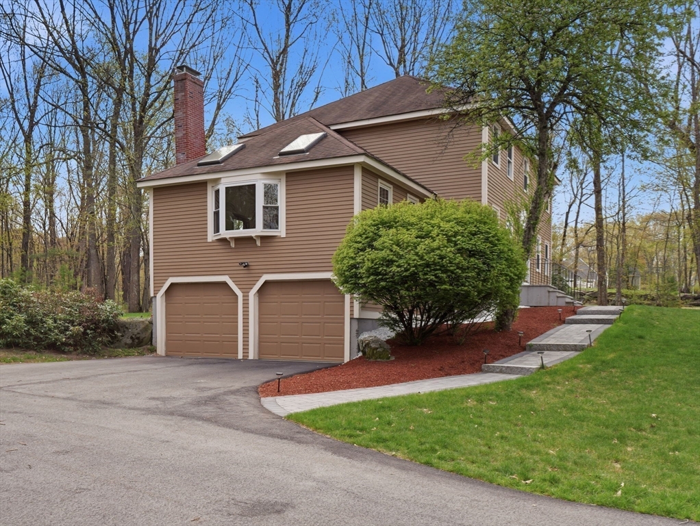 26 Nevada Road Tyngsborough, MA 01879 - Photo 2 of 42 a front view of a house with garden