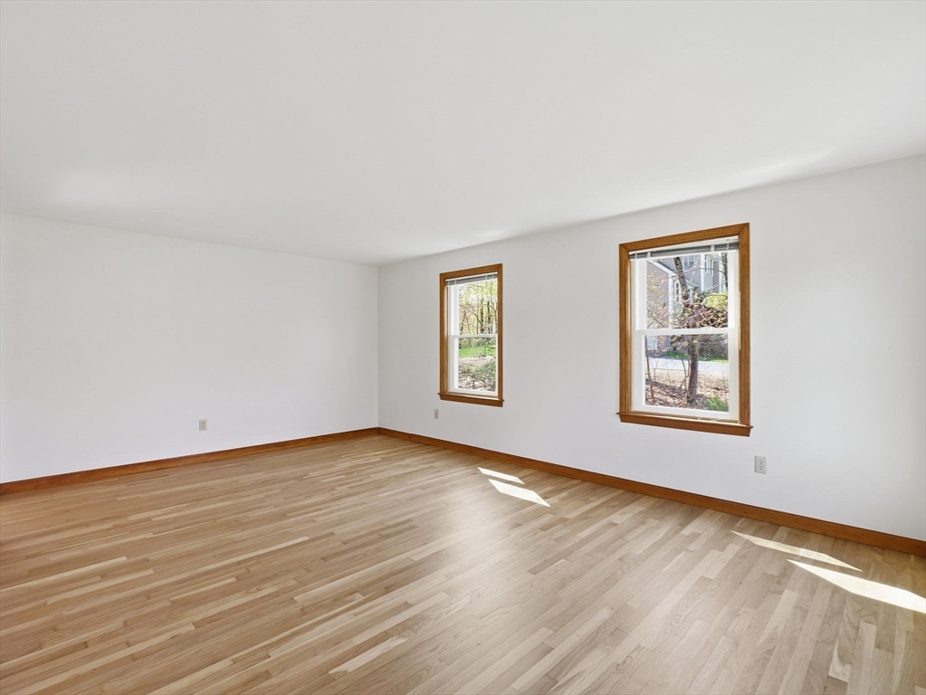 26 Nevada Road Tyngsborough, MA 01879 - Photo 21 of 42 a view of an empty room with wooden floor and a window