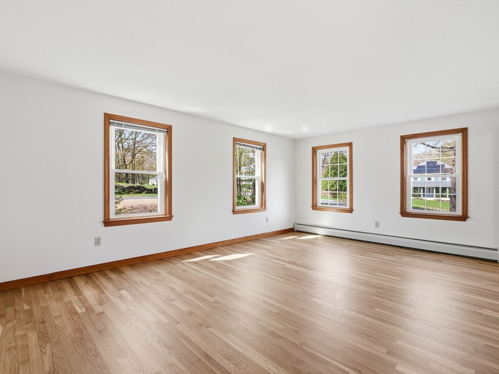 26 Nevada Road Tyngsborough, MA 01879 - Photo 22 of 42 a view of an empty room with window and wooden floor