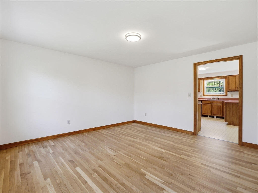 26 Nevada Road Tyngsborough, MA 01879 - Photo 23 of 42 an empty room with wooden floor and windows