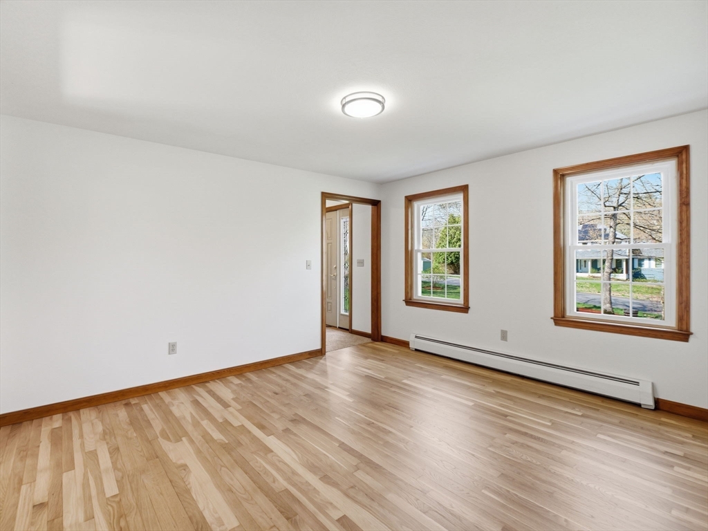 26 Nevada Road Tyngsborough, MA 01879 - Photo 25 of 42 an empty room with wooden floor and windows