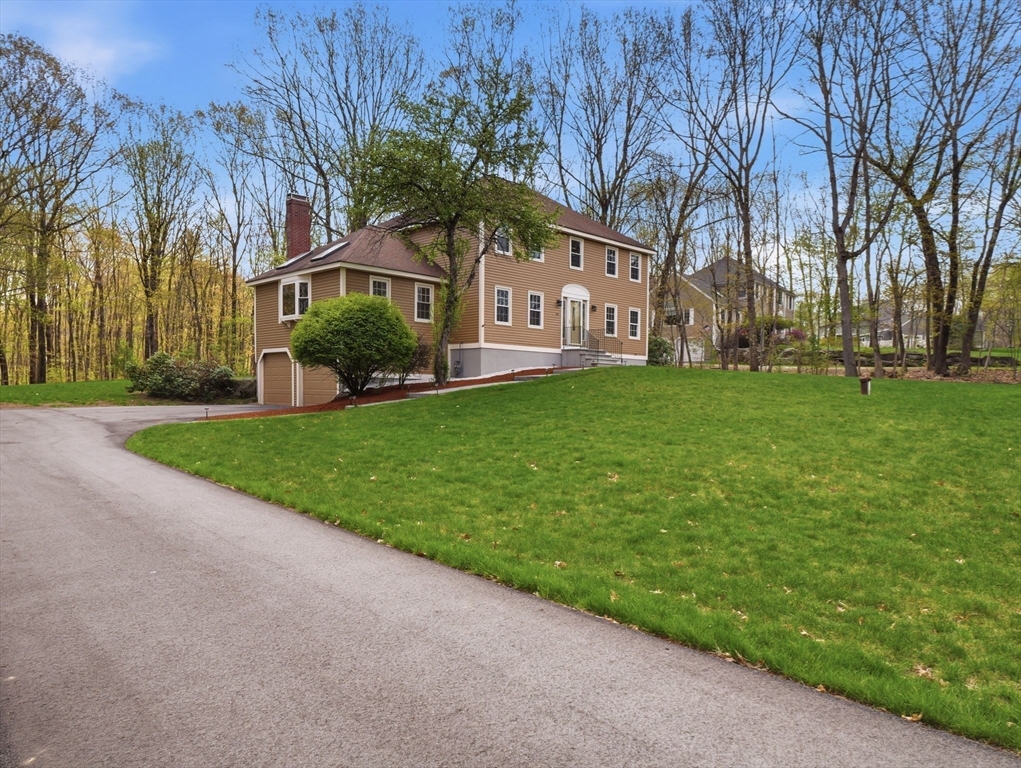 26 Nevada Road Tyngsborough, MA 01879 - Photo 3 of 42 a front view of a house with garden