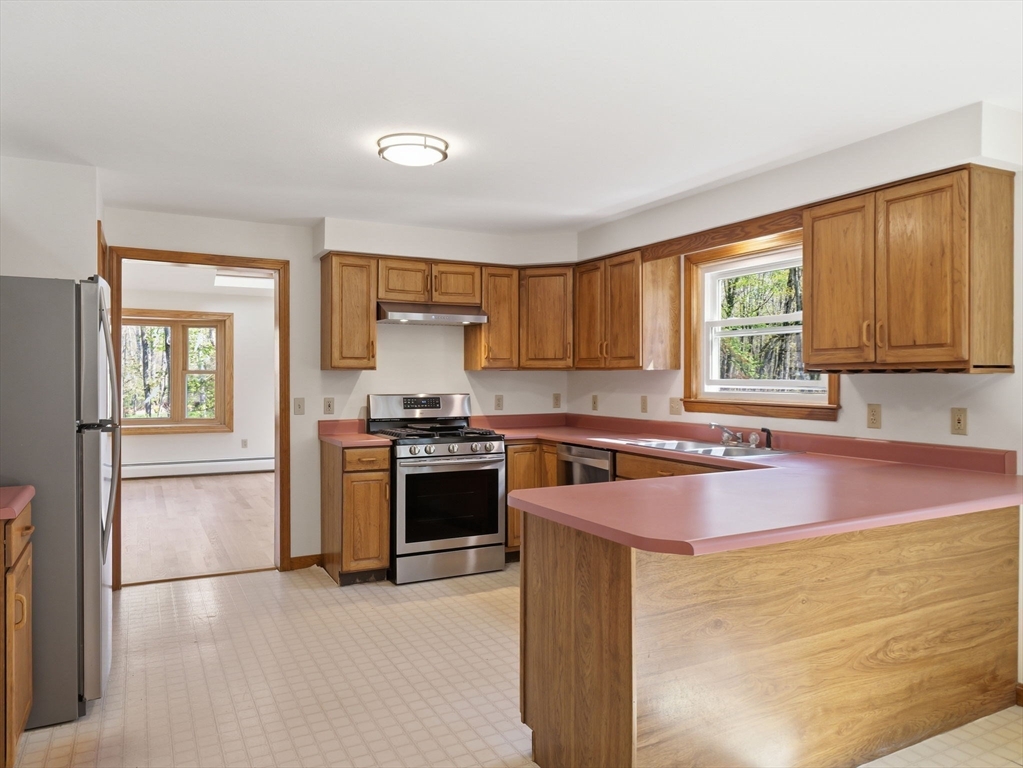 26 Nevada Road Tyngsborough, MA 01879 - Photo 5 of 42 a kitchen with granite countertop cabinets stainless steel appliances and a window