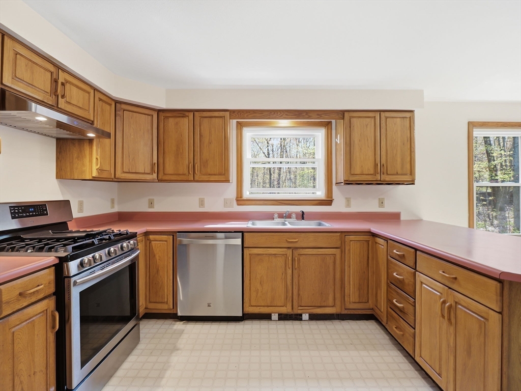 26 Nevada Road Tyngsborough, MA 01879 - Photo 7 of 42 a kitchen with stainless steel appliances granite countertop a stove sink and cabinets