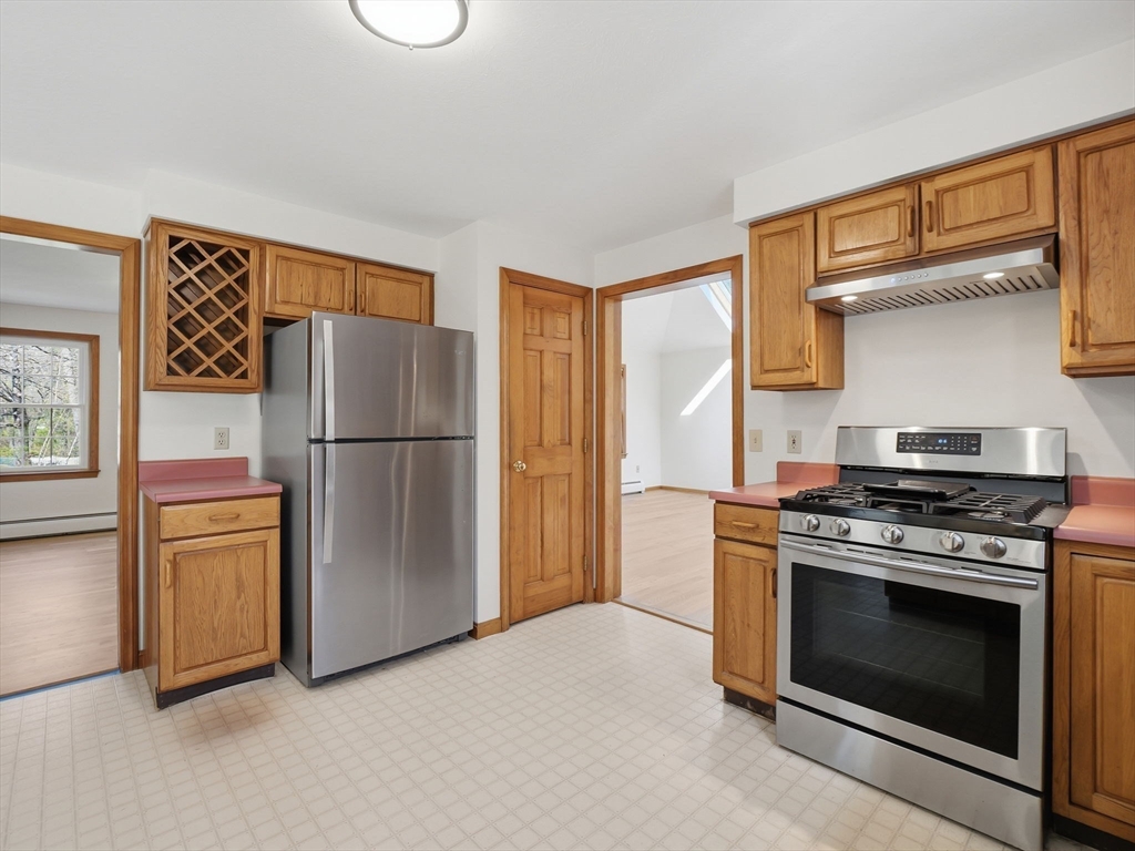 26 Nevada Road Tyngsborough, MA 01879 - Photo 8 of 42 a kitchen with refrigerator a stove and a refrigerator