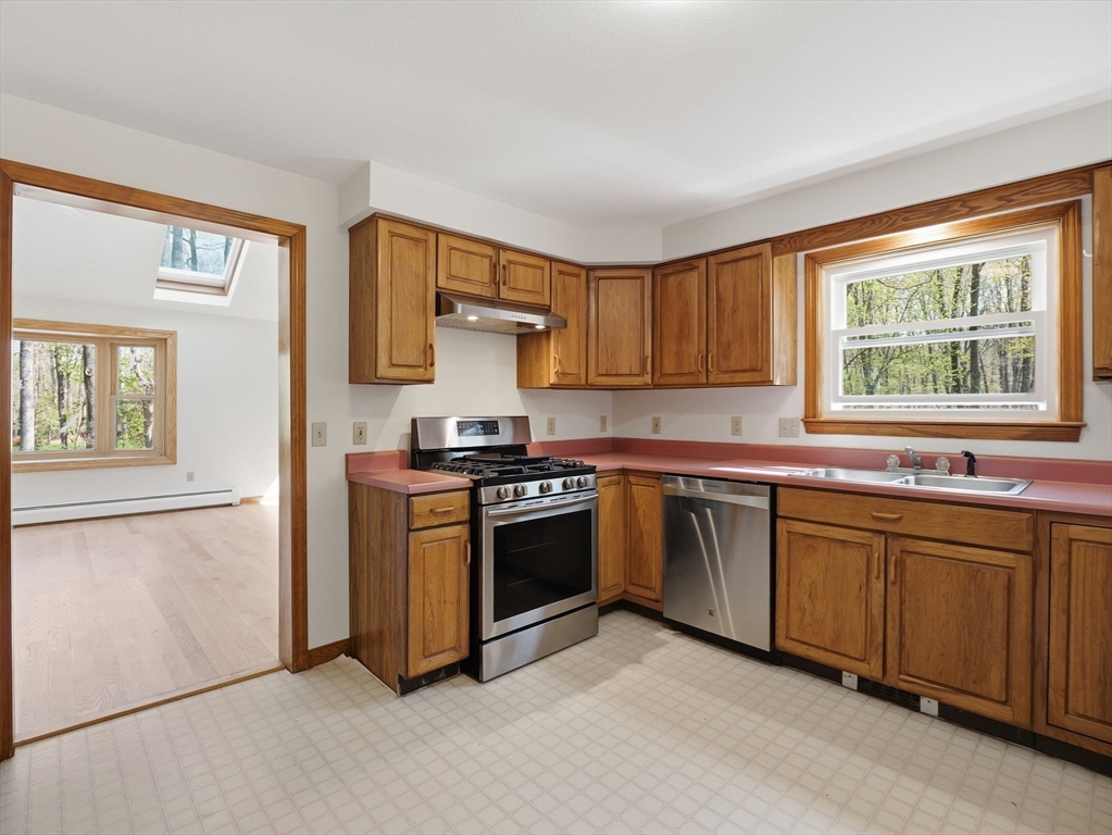 26 Nevada Road Tyngsborough, MA 01879 - Photo 10 of 42 a kitchen with stainless steel appliances granite countertop a stove a sink and a refrigerator