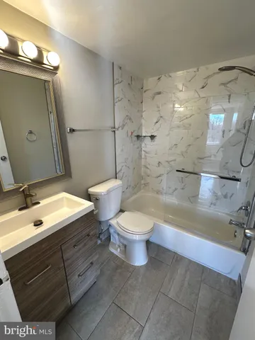 a bathroom with a toilet sink and a mirror