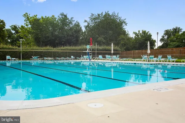 a view of a swimming pool with a yard