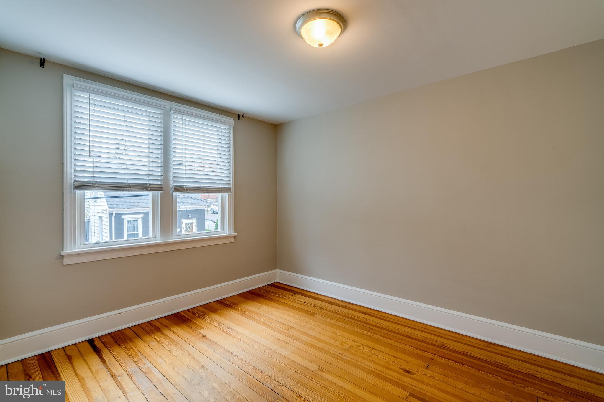 679 Poplar Street Lancaster, PA 17603 - Photo 18 of 32 an empty room with wooden floor and windows