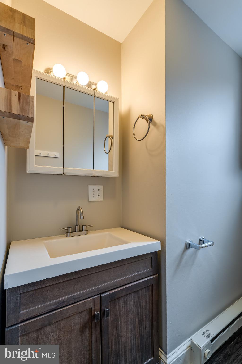 679 Poplar Street Lancaster, PA 17603 - Photo 21 of 32 a bathroom with a sink and a mirror