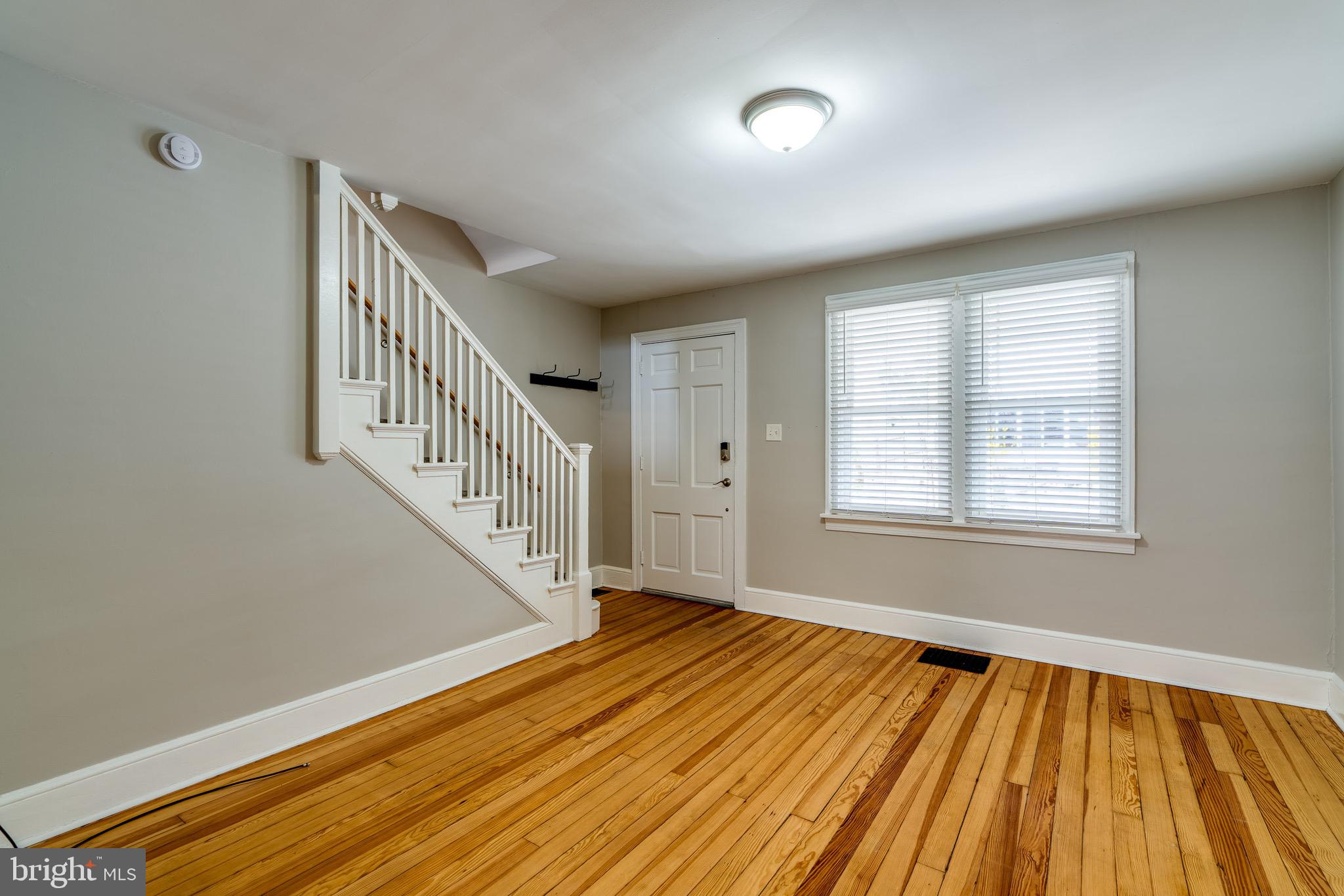 679 Poplar Street Lancaster, PA 17603 - Photo 8 of 32 a view of an empty room with wooden floor and a window