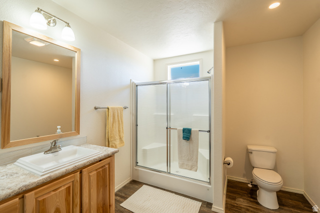 700 East Peter Springs Road Monticello, UT 84535 - Photo 22 of 57 Bathroom featuring a wood-finish vanity with an integrated sink, a framed mirror, and an overhead light fixture