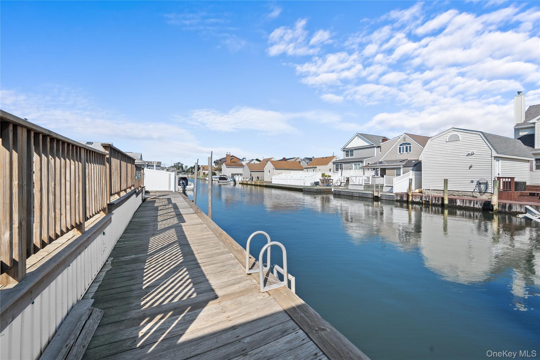 15 Hayes Road Amity Harbor, NY 11701 - Photo 23 of 46 a view of a lake with boats and trees in the background