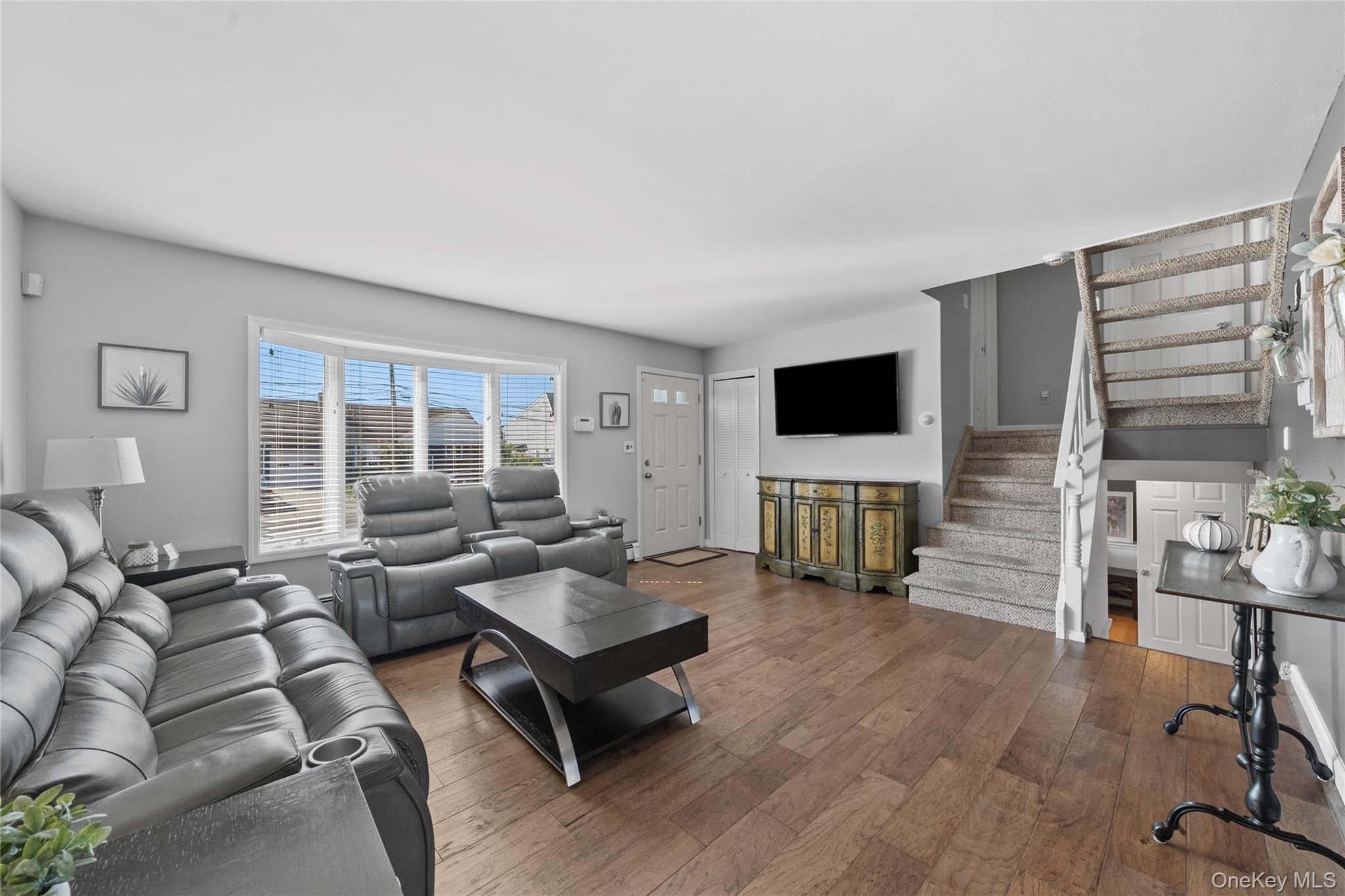 15 Hayes Road Amity Harbor, NY 11701 - Photo 4 of 46 a living room with furniture and a flat screen tv