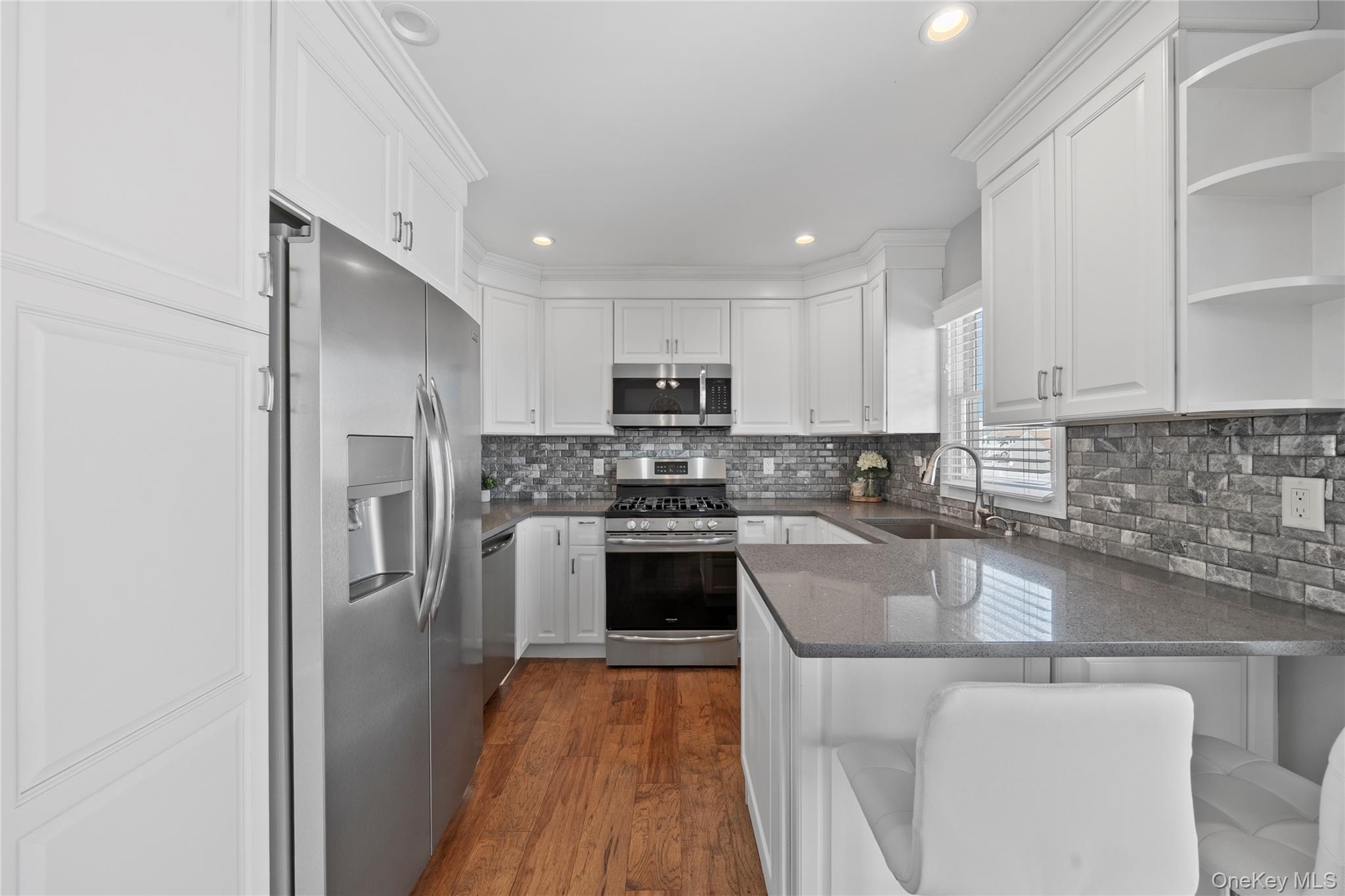 15 Hayes Road Amity Harbor, NY 11701 - Photo 9 of 46 a kitchen with stainless steel appliances granite countertop a refrigerator sink and stove