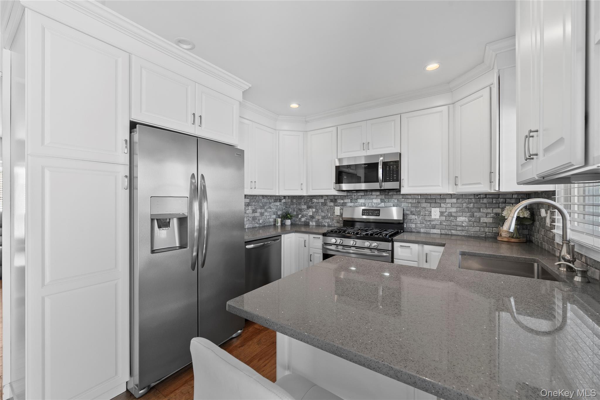 15 Hayes Road Amity Harbor, NY 11701 - Photo 10 of 46 a kitchen with stainless steel appliances granite countertop a refrigerator stove microwave and sink