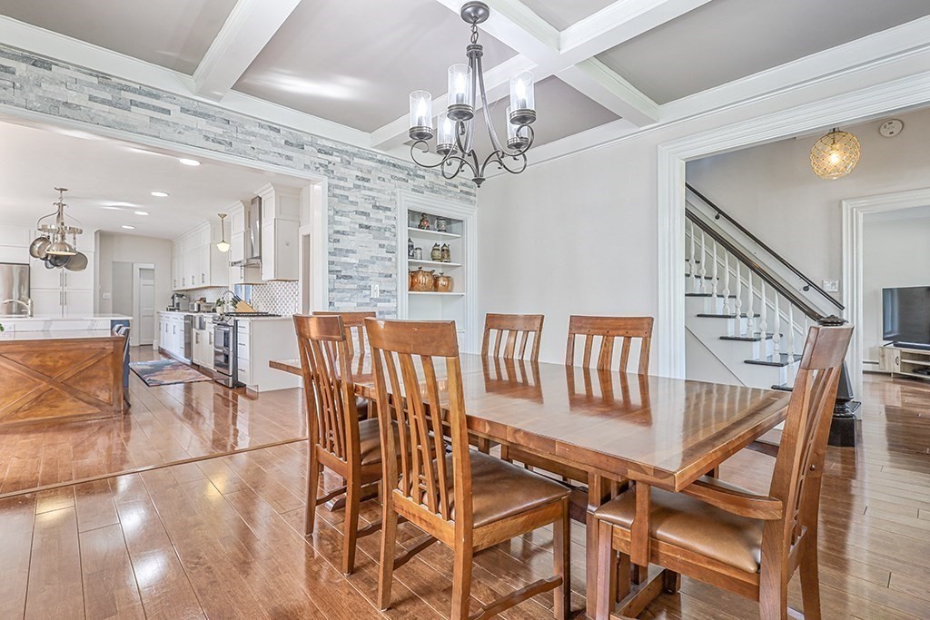 28 Maple Street Mendon, MA 01756 - Photo 14 of 39 a view of a dining room and livingroom with furniture wooden floor and a chandelier