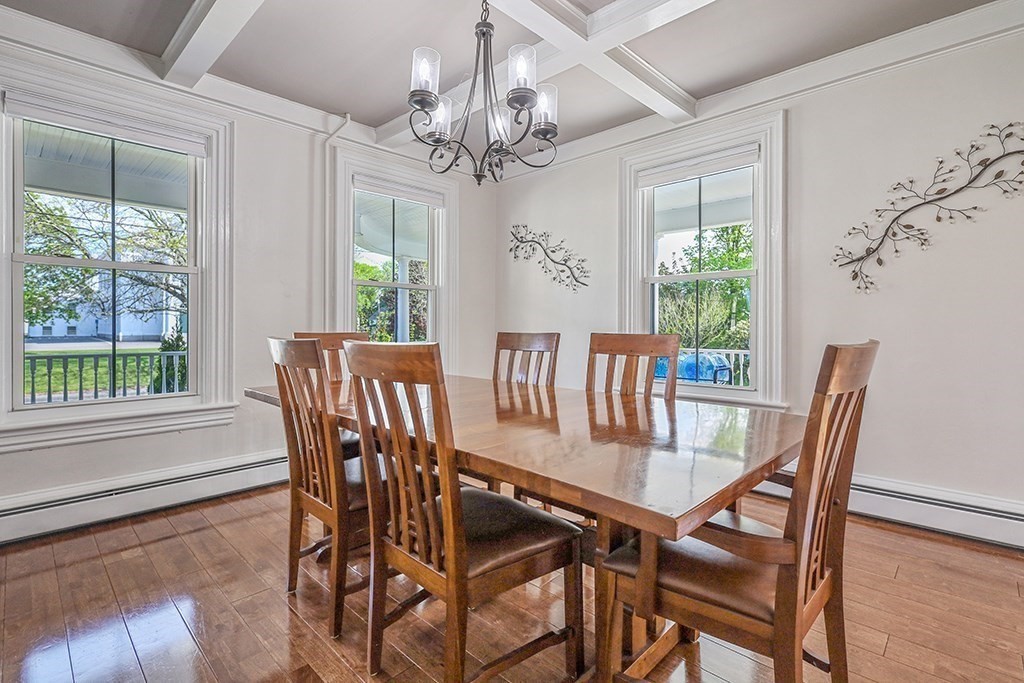 28 Maple Street Mendon, MA 01756 - Photo 16 of 39 a view of a dining room with furniture a chandelier and wooden floor