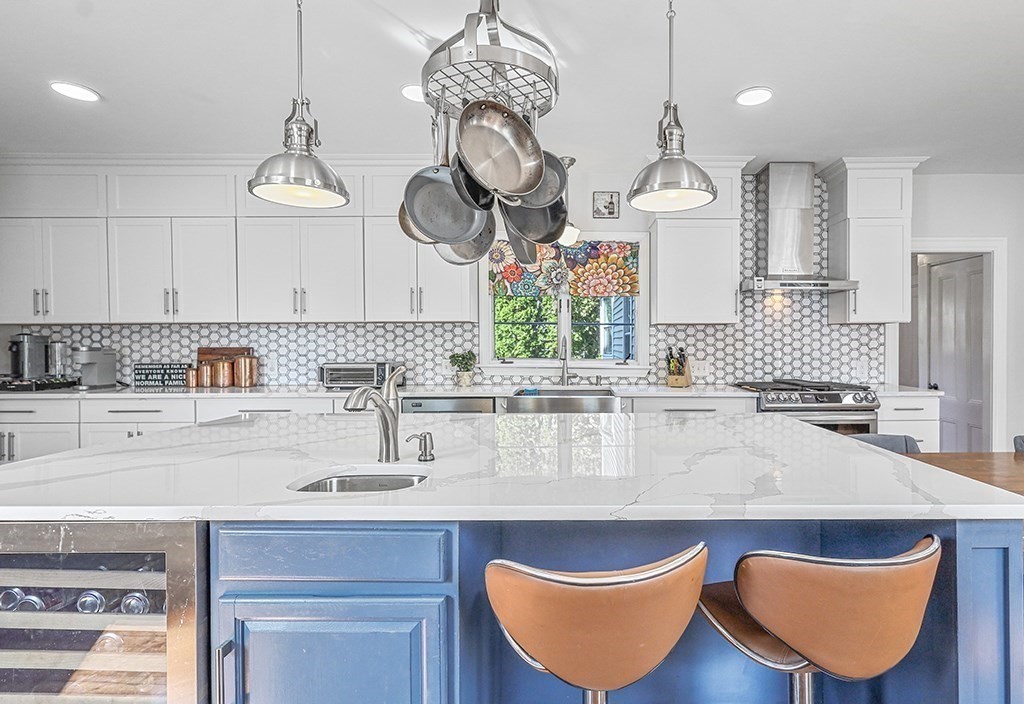 28 Maple Street Mendon, MA 01756 - Photo 18 of 39 a kitchen with stainless steel appliances granite countertop a sink a stove and a wooden floors