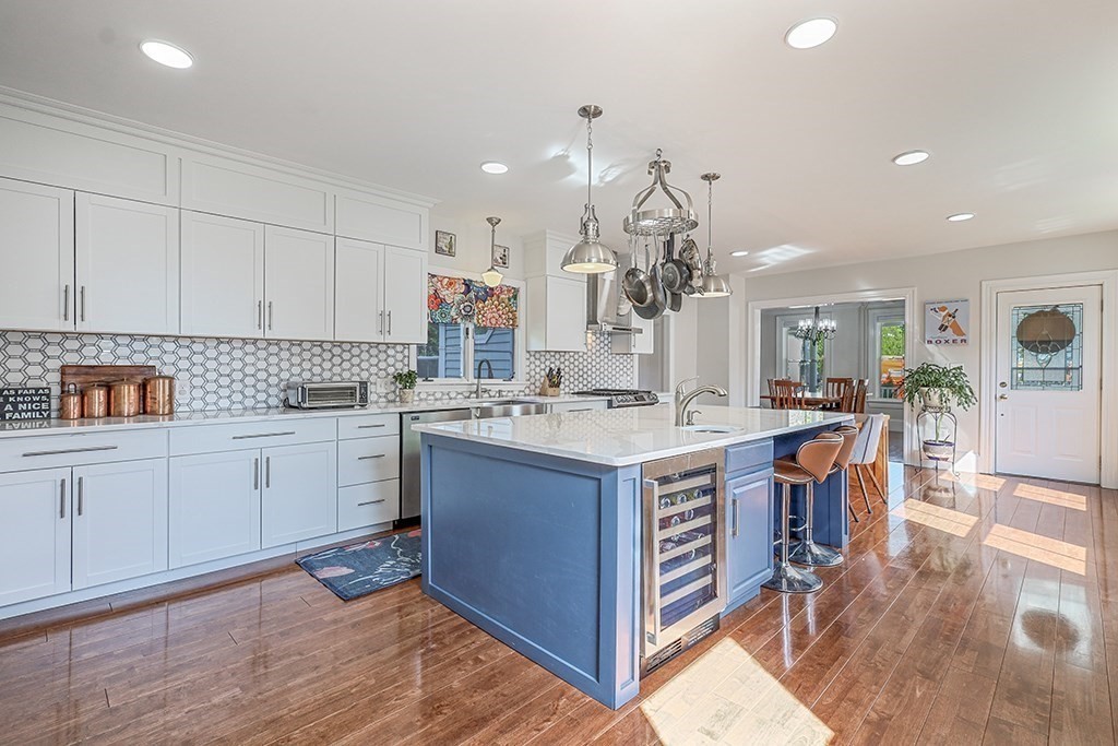 28 Maple Street Mendon, MA 01756 - Photo 19 of 39 a kitchen with stainless steel appliances granite countertop a lot of counter space and wooden floors
