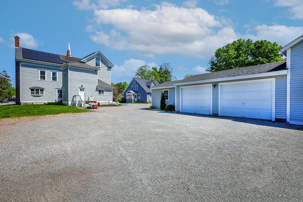 28 Maple Street Mendon, MA 01756 - Photo 2 of 39 a front view of a house with a yard and garage