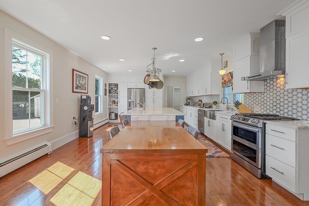 28 Maple Street Mendon, MA 01756 - Photo 22 of 39 a kitchen with stainless steel appliances granite countertop a sink stove and refrigerator