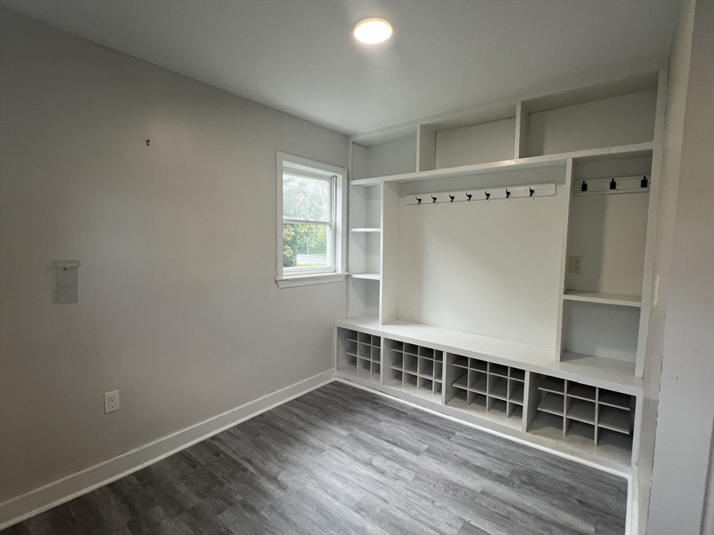 28 Maple Street Mendon, MA 01756 - Photo 23 of 39 an empty room with wooden floor and windows