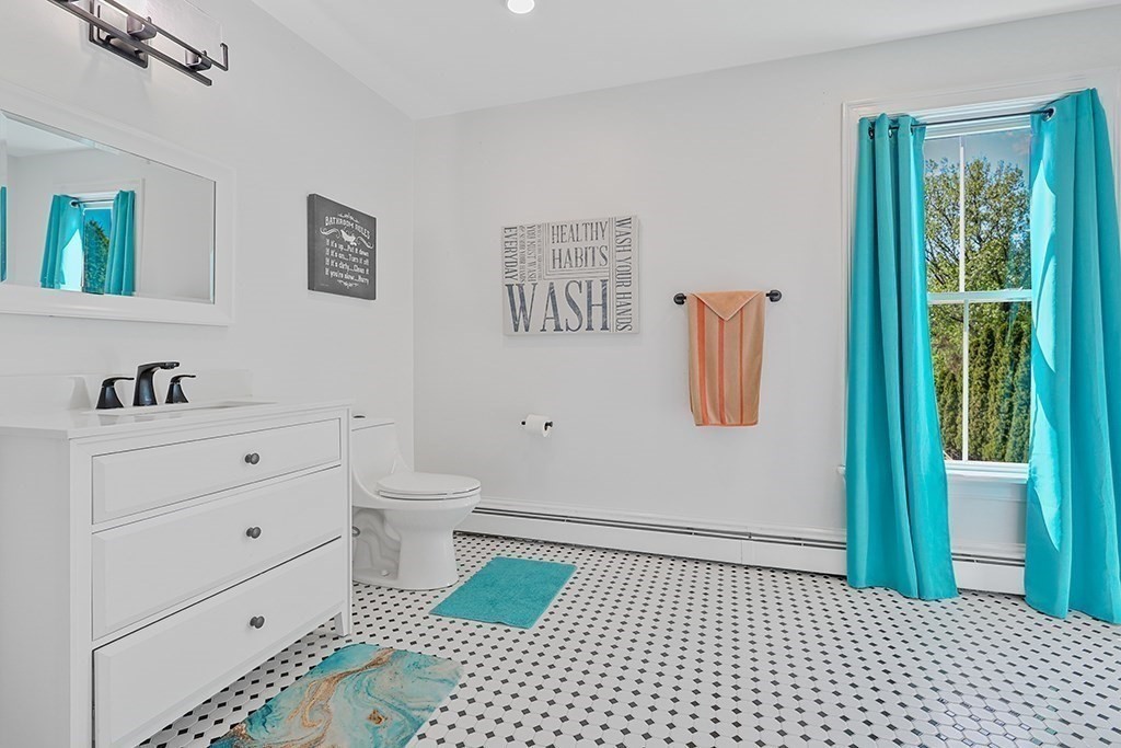 28 Maple Street Mendon, MA 01756 - Photo 33 of 39 a bathroom with a sink a toilet and a shower