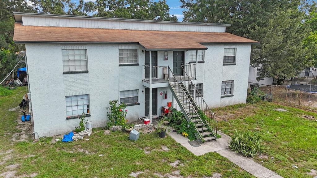 1806 East 138th Avenue Tampa, FL 33613 - Photo 2 of 19 a front view of a house with garden