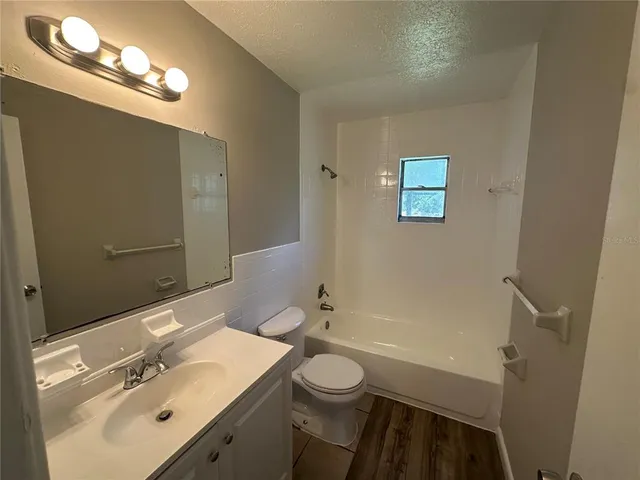 a bathroom with a sink vanity mirror and toilet