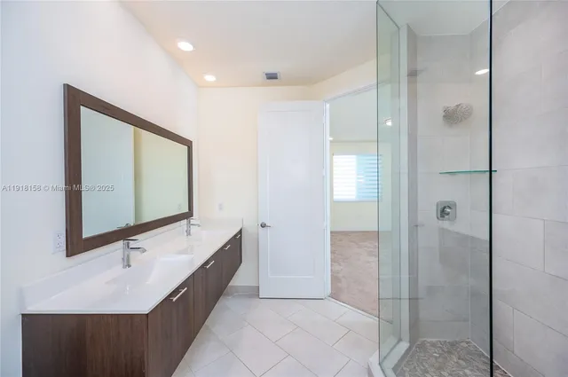a bathroom with a bathtub sink and mirror