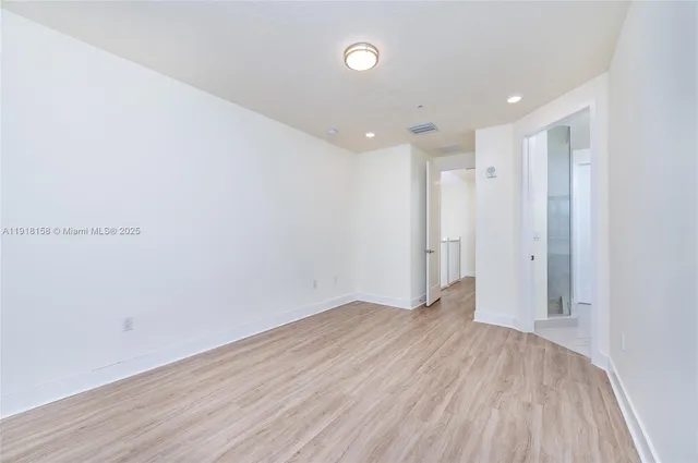 a view of a room with wooden floor