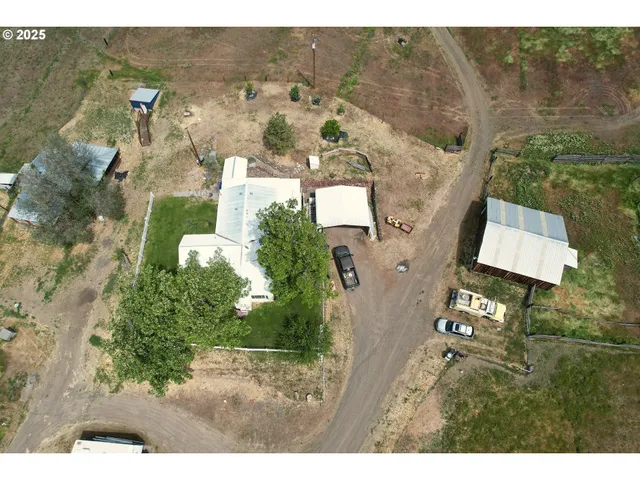 a view of a lake with a yard and a large tree