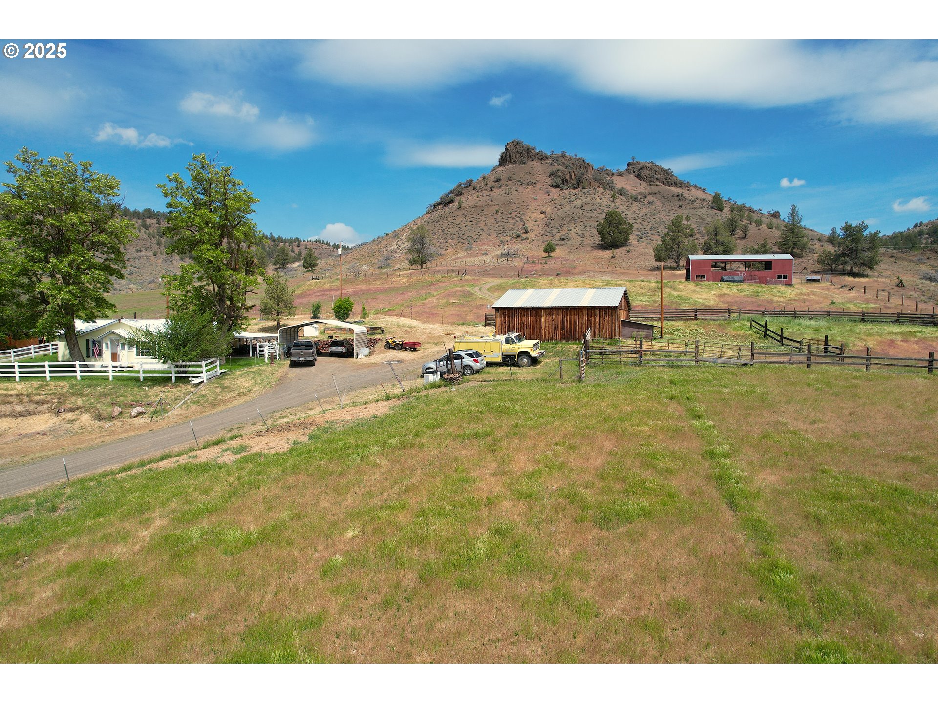 40300 Kahler Basin Road Spray, OR 97874 - Photo 25 of 26 a view of a lake with a yard and a large tree