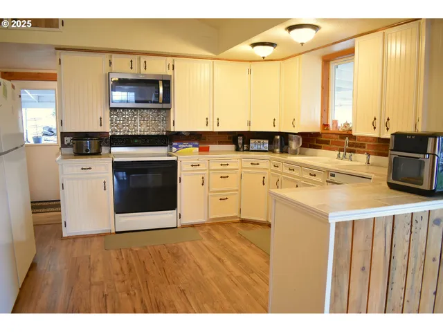 a kitchen with a stove a sink and a microwave