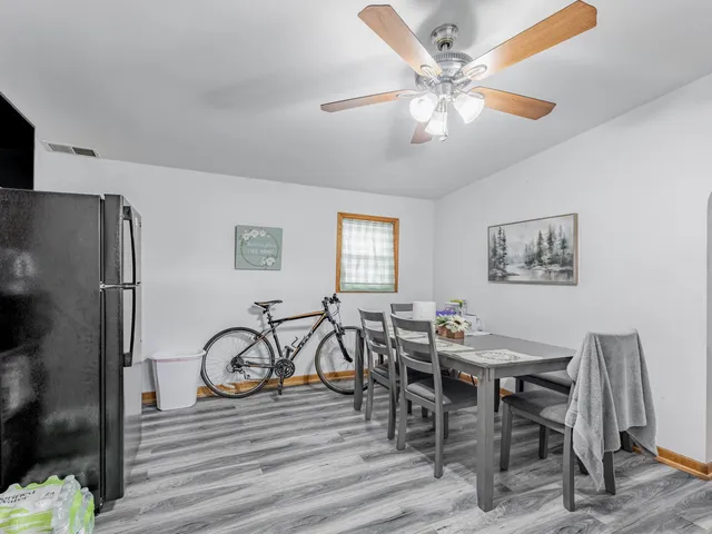 a view of a dining room with furniture and wooden floor