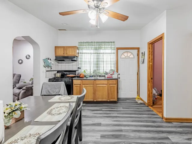 a kitchen with stainless steel appliances granite countertop a stove and a refrigerator