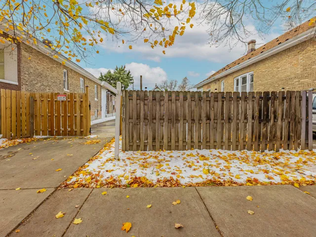 a view of backyard with wooden fence